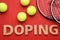 Flat lay composition with word Doping, tennis balls and rackets on red background