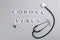 Flat lay composition with words CORONA VIRUS, stethoscope and syringe on light grey