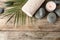 Flat lay composition with zen stones, towel and candle on wooden background