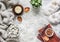 Flat lay cozy home still life - stack of books, knitted plaid, candle, chrysanthemum bouquet, fur carpet, soft slippers, succulent