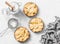 Flat lay crispy shortcrust pastry apple tartlets in the baking dish on light background, top view.