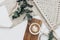 Flat lay Cup of coffee on wooden serving tray and eucalyptus branch