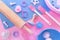 Flat lay with cute pink and blue baking utensils like wooden rolling pin, mixing bowl, cookie cutters and stamps and baking mat