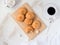 flat lay - a delicious round biscuit cookie on a bamboo cutting board on a white background, a cup of coffee, refined sugar