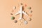 Flat lay design of travel concept with plane in a circle of seashells, starfishes and stone on brown background
