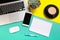 Flat lay design of work desk with labtop notebook, smartphone and cactus on green and yellow background