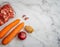 Flat lay of diced lamb, carrots, red onion, garlic and ginger on a white  marbled worktop