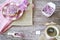 Flat lay, Dutch breakfast with rusk, cup of tea, pink sweet sprinkles, hail on plate, against wooden background