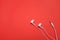 Flat lay  Earphones on isolate red background.