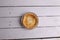 Flat lay of an egg tart in an aluminum foil tray  isolated on a white rustic background