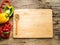 Flat lay of empty blank wooden chopping board with wooden spoon