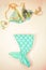 Flat lay fashion set: Mint colour mermaid tail and top of swimming suit.