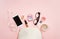 Flat lay female accessories cosmetics glasses mobile phone headphones alarm clock on pink background. Valentine`s Day 8 March