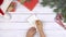 Flat lay of female hand writing 2021 to do list, Christmas decoration around, wooden background.