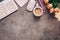 Flat lay female workspace - modern keyboard, mouse, cup of coffee, rose flowers, jewelry and stationery on a dark rustic