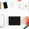 Flat lay feminine workspace tablet notebook smartphone flowers personal accessories