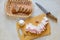 Flat lay of food composition, cutting board with Ukrainian food, lard, garlic and peppercorn, having knife and bread in bread box