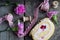 Flat lay food - dough biscuit roll, wooden bobbins, ribbon and pink carnations flowers on wooden background