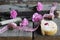 Flat lay food - dough biscuit roll, wooden bobbins, ribbon and pink carnations flowers on wooden background