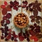 Flat lay frame of autumn crimson leaves with basket walnuts on a