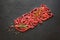 Flat-lay of fresh raw beef meat on black table.