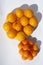 Flat lay fresh tangerines citrus fruits with shadows on a white background, plastic package summer food concept