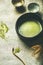 Flat-lay of freshly brewed Japanese matcha green tea in bowl