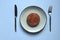 Flat lay of fried veggie burger, cutlet on a blue plate close up. Fork and knife. Dinner. Restaurant menu. Copy space.