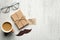 Flat lay gift box with label Happy Fathers Day, mustache, glasses, cup of coffee on wooden table. Top view Father`s day