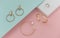 Flat lay of golden jewelries on pastel colors background