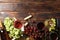 Flat lay. Grapes, corkscrew, bottles and glasses with wine on wooden table