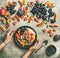 Flat-lay of Greek yogurt, fruit, chia seeds bowl in hands