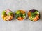 Flat lay Hawaiian salmon and shrimp poke bowls with seaweed, avocado, mango, raw vegetables, sesame seeds. Top view, copy space