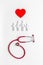 Flat lay with heart, stethoscope and family figure. Medical care concept