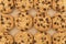 Flat lay of homemade chocolate chip cookies on burlap.