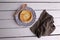 Flat lay of a homemade egg tart with a wooden spoon on a rustic wooden background