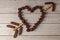 Flat lay image of Chocolate truffles designed in outline of heart shape with an arrow made of cookies going through it.