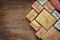 Flat lay image of handmade gift boxes over wooden background