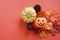 Flat lay of Jack O lantern pumpkins face on autumn leaves