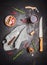Flat lay with kitchen cooking tools, glass of red wine, herbs and spices on dark rustic background