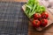 Flat lay. Kitchen table with lettuce and red tomatoes. Copy space