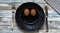 Flat lay of kitchen utensil and two eggs on plate making a smiley face on colored wooden background