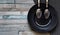 Flat lay of kitchen utensil and two spoons on plate making a smiley face on colored wooden background