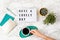 Flat lay with lightbox with text Have a lovely day and coffee cup. Social media, motivation quote, feminine blog, morning of