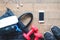 Flat lay of mobile phone, water bottle, towel and red dumbbells on wood