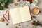 Flat lay of Mockup blank notepad for Christmas goals. Gray background with cup of coffee, fir branch, gift, empty