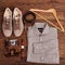 Flat lay of modern men`s clothing on a brown wooden background