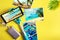 Flat lay monopod with a smartphone and photos on a yellow background. Summer travel concept