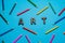 flat lay multicolored pencils and inscription art on a bright blue background