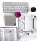 Flat lay: open book, keyboard, coffee, black pen, to do list, silver and pink, purple, violette, red Gerbera flower with petals